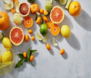 Photo of various citrus fruits including oranges, lemons, limes, and grapefruit